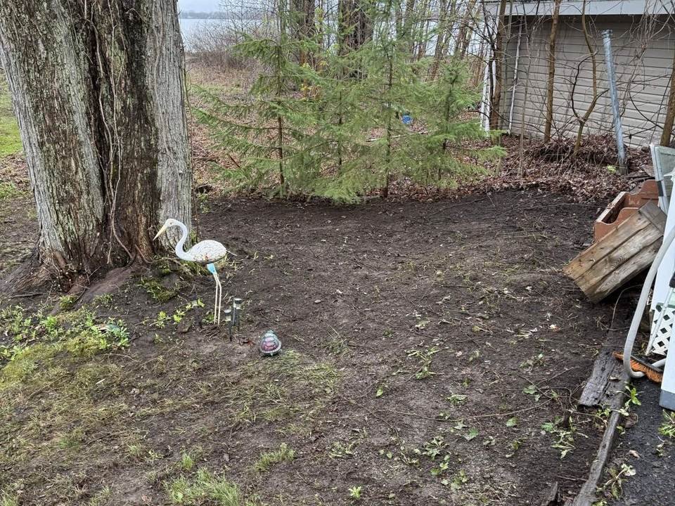 Leaves and debris cleared from a garden bed after a fall cleanup