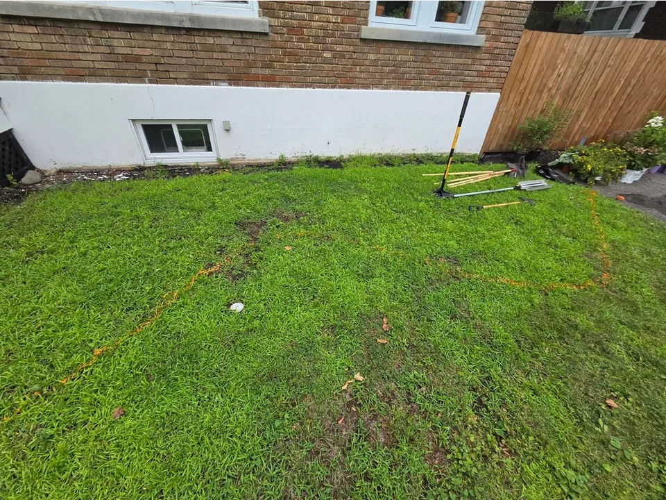 Foundation garden in front of a brick house with white columns — before