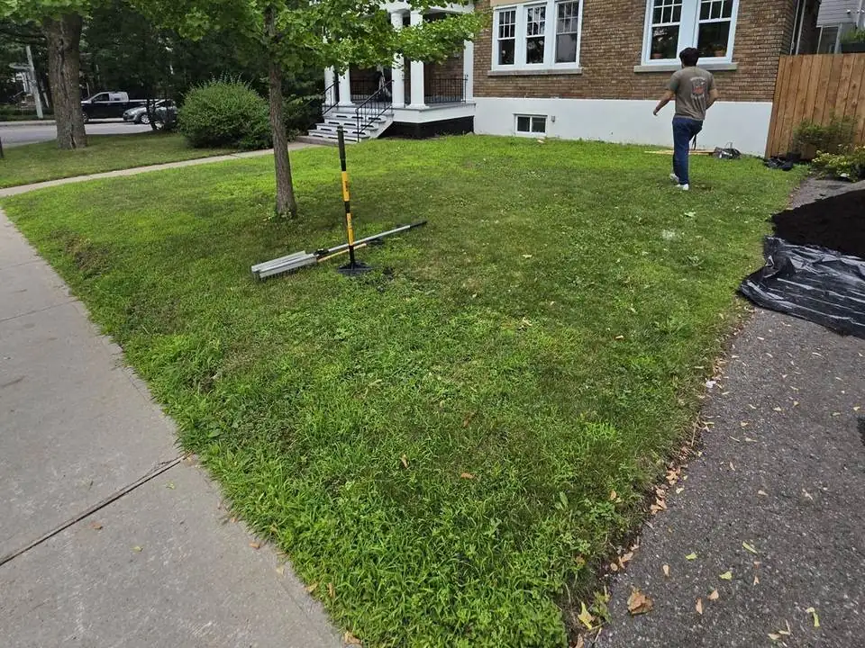New mulched garden bed and stepping-stone path in a front lawn — before