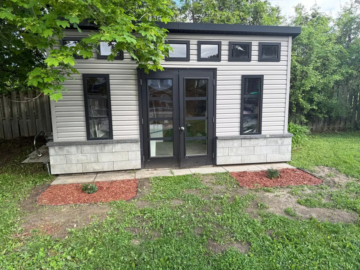 Garden room with fresh mulch beds on both sides of the doors